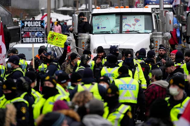 February 11, 2022, Ottawa, ON, CAN: A protester records police as they form a ring around protesters who were building a tent structure on Wellington Street, on the 15th day of a protest against COVID-19 measures that has grown into a broader anti-government protest, in Ottawa, Friday, Feb. 11, 2022. Ottawa CAN  - ZUMAc35_ 20220211_zaf_c35_173 Copyright: xJustinxTangx