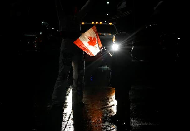 February 11, 2022, WINDSOR, ON, CANADA: A young girl dances as truckers and supporters block the access leading from the Ambassador Bridge, linking Detroit and Windsor, as truckers and their supporters continue to protest against the COVID-19 vaccine mandates and restrictions in Windsor, Ont., on Friday, February 11, 2022. WINDSOR CANADA - ZUMAc35_ 20220211_zaf_c35_197 Copyright: xNathanxDenettex