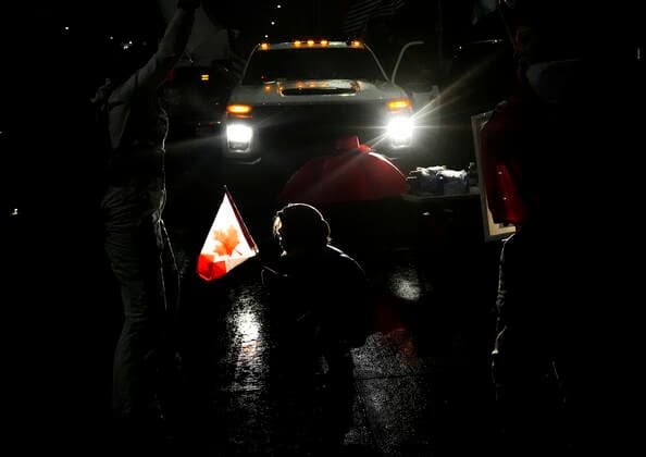 February 11, 2022, WINDSOR, ON, CANADA: A young girl dances as truckers and supporters block the access leading from the Ambassador Bridge, linking Detroit and Windsor, as truckers and their supporters continue to protest against the COVID-19 vaccine mandates and restrictions in Windsor, Ont., on Friday, February 11, 2022. WINDSOR CANADA - ZUMAc35_ 20220211_zaf_c35_202 Copyright: xNathanxDenettex