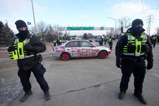 February 12, 2022, Windsor, ON, CANADA: Police look on as a protest vehicle leaves a demonstration which has blocked traffic across the Ambassador Bridge by protesters against COVID-19 restrictions prior to police enforcement of an injuction against the protesters, in Windsor, Ont., Saturday, Feb. 12, 2022. Windsor CANADA  - ZUMAc35_ 20220212_zaf_c35_079 Copyright: xNathanxDenettex