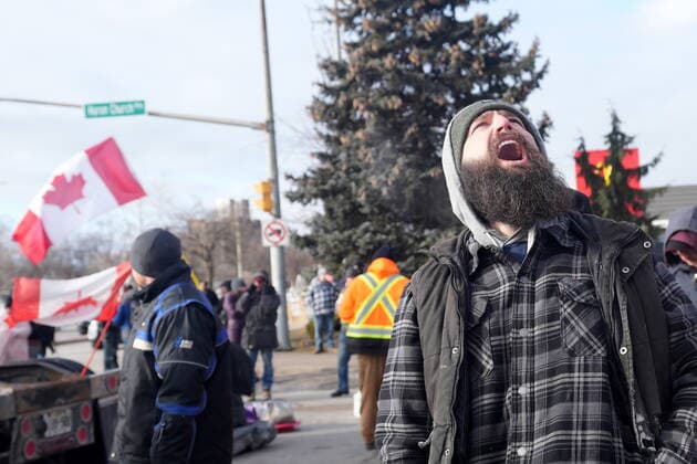 February 12, 2022, Windsor, ON, CANADA: A protester yells freedom as demonstrators prepare to leave in advance of police enforcing an injunction against their demonstration, which has blocked traffic across the Ambassador Bridge by protesters against COVID-19 restrictions, in Windsor, Ont., Saturday, Feb. 12, 2022. Windsor CANADA - ZUMAc35_ 20220212_zaf_c35_095 Copyright: xNathanxDenettex