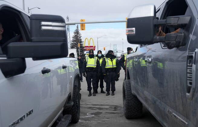 February 12, 2022, Windsor, ON, CANADA: Police enforce an injunction at a demonstration which has blocked traffic across the Ambassador Bridge by protesters against COVID-19 restrictions, in Windsor, Ont., Saturday, Feb. 12, 2022. Windsor CANADA  - ZUMAc35_ 20220212_zaf_c35_129 Copyright: xNathanxDenettex
