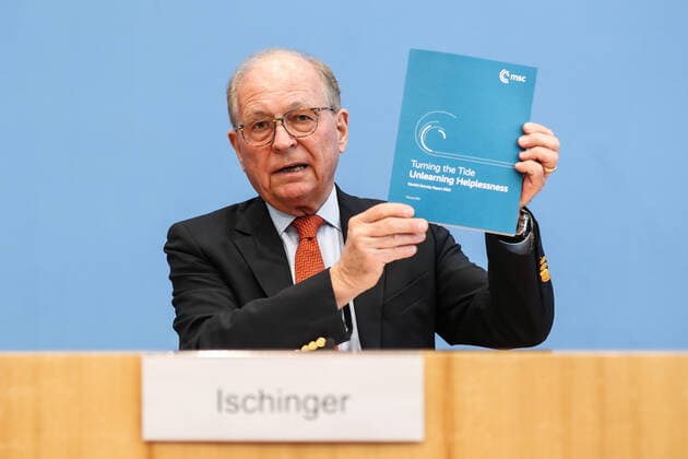(220215) -- BERLIN, Feb. 15, 2022 -- Chairman of the Munich Security Conference (MSC) Wolfgang Ischinger holds a copy of Munich Security Report during a press conference in Berlin, capital of Germany, Feb. 14, 2022. Participants in the forthcoming 58th edition of the Munich Security Conference (MSC) will discuss the findings of a 180-page report titled Turning the Tide - Unlearning Helplessness, which warns of a mounting feeling of helplessness in many societies of the world in the face of a growing number of crises and conflicts. The Munich Security Report, released here on Monday, is published annually ahead of the MSC. It sets the tone for the conference, which is often referred to as the Davos of global security and is to be 