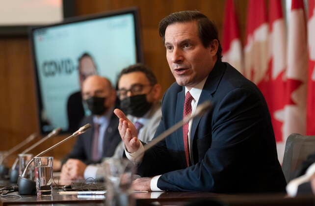 February 15, 2022, Ottawa, ON, Canada: Public Safety Minister Marco Mendicino responds to a question as Health Minister Jean-Yves Duclos and ..Minister of Transport Omar Alghabra look on during a news conference, Tuesday, Feb. 15, 2022 in Ottawa. Ottawa Canada  - ZUMAc35_ 20220215_zaf_c35_158 Copyright: xAdrianxWyldx