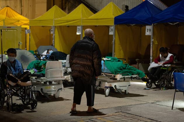 Coronavirus Emergency In Hong Kong An elderly COVID patient walks around the patient hosting area outside the Accident and Emergency ward at the Caritas Medical Centre in Sham Shui Po, Hong Kong. The temperatures were predicted to reach lows of 13Â° C in the morning. Patients had to be hosted outdoors as hospitals in Hong Kong have been overwhelmed with the omicron outbreak. Hong Kong China  Copyright: xMarcxFernandesx originalFilename: fernandes-hongkong220215_np7JH.jpg