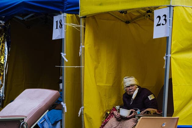 February 17, 2022, Hong Kong, China: Covid-19 patients sleep and wait at a temporary triage area outside the Caritas Medical Center hospital. As the fifth wave of Covid surges, cases worsen in Hong Kong as daily cases reaching the 5,000 mark. Hong Kong has adopted the China s Zero Covid Policy to suppress all outbreaks and by all necessary measures to get the virus under control. Hong Kong China - ZUMAt141 20220217_zap_t141_001 Copyright: xKeithxTsujix