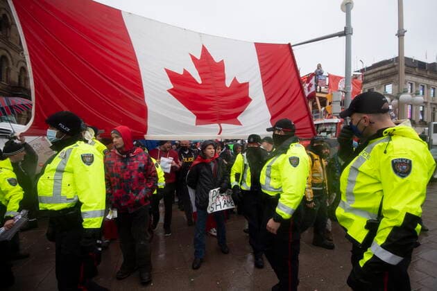 February 17, 2022, Ottawa, ON, CAN: Police are followed by yelling protesters as they attempt to hand out a notices to protesters on the 21st day of a protest against COVID-19 measures that has grown into a broader anti-government protest, in Ottawa, on Thursday, Feb. 17, 2022. Ottawa CAN  - ZUMAc35_ 20220217_zaf_c35_058 Copyright: xJustinxTangx