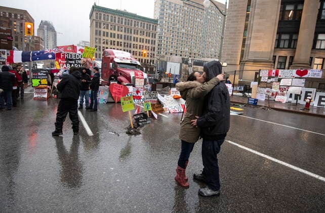 February 17, 2022, Ottawa, ON, CAN: A couple kiss as a pop song plays on a speaker in front parked trucks on Rideau Street 21st day of a protest against COVID-19 measures that has grown into a broader anti-government protest, in Ottawa, on Thursday, Feb. 17, 2022. Ottawa CAN  - ZUMAc35_ 20220217_zaf_c35_212 Copyright: xJustinxTangx
