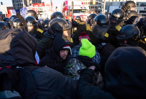February 18, 2022, Ottawa, ON, CAN: Police push forward as protesters attempt to maintain their position at a blockade of vehicles at Rideau Street as police work to end an ongoing protest against COVID-19 measures that has grown into a broader anti-government protest, on its 22nd day, in Ottawa, on Friday, Feb. 18, 2022. Ottawa CAN  - ZUMAc35_ 20220218_zaf_c35_234 Copyright: xJustinxTangx