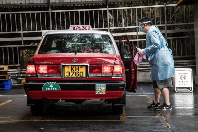 February 19, 2022, Hong Kong, China: A taxi driver disinfects his vehicle after dropping off patients at a COVID-19 clinic in Shau Kei Wan..A fleet of around 300 designated taxis were launched recently to ferry passengers to and from designated COVID-19 clinics in Hong Kong. The drivers are provided with PPE and a 3000 HKD per day stipend from the government, while passengers ride for free (pending approval of their booking). Drivers are required to clean their vehicles thoroughly between rides, take regular COVID-19 tests, and passengers may only sit in the back. Hong Kong China - ZUMAs197 20220219_zaa_s197_008 Copyright: xBenxMaransx