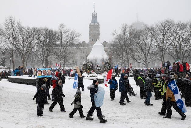 February 19, 2022, QUEBEC, PQ, Canada: Families walk the street as hundreds of people demonstrate against COVID-19 measures in front of the legislature in Quebec City, Saturday, Feb. 19, 2022. QUEBEC Canada  - ZUMAc35_ 20220219_zaf_c35_093 Copyright: xJacquesxBoissinotx