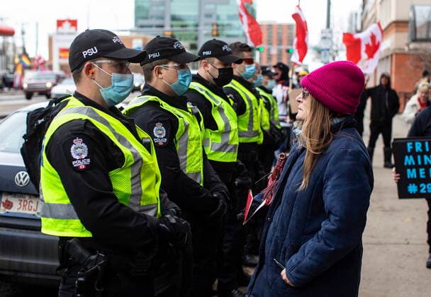 February 19, 2022, EDMONTON, AB, CANADA: A protester faces off with police as demonstrators gathered to protest against COVID-19 measures and in support of a demonstration in Ottawa which has grown to a broader anti-government demonstration, in Edmonton, Saturday, Feb. 19, 2022. EDMONTON CANADA  - ZUMAc35_ 20220219_zaf_c35_131 Copyright: xJasonxFransonx