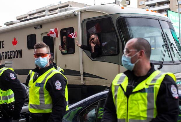 February 19, 2022, EDMONTON, AB, CANADA: Police line the street after pulling over a motorhome that was making excessive noise as demonstrators gathered to protest against COVID-19 measures and in support of a demonstration in Ottawa which has grown to a broader anti-government demonstration, in Edmonton, Saturday, Feb. 19, 2022. EDMONTON CANADA  - ZUMAc35_ 20220219_zaf_c35_132 Copyright: xJasonxFransonx