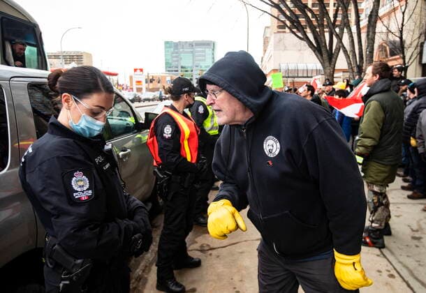 February 19, 2022, EDMONTON, AB, CANADA: A protestor confronts an officer as demonstrators gathered to protest against COVID-19 measures and in support of a demonstration in Ottawa which has grown to a broader anti-government demonstration, in Edmonton, Saturday, Feb. 19, 2022. EDMONTON CANADA  - ZUMAc35_ 20220219_zaf_c35_134 Copyright: xJasonxFransonx