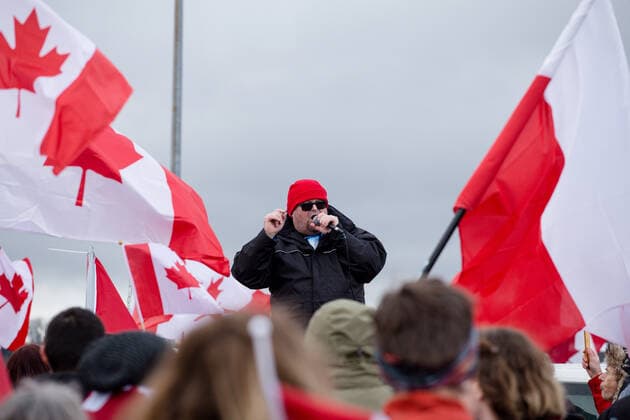 February 19, 2027, Surrey, British Columbia, Canada: A person speaks to the crowd gathered at the tucker border. This is the second weekend that crowds have gathered at this border crossing to protest pandemic mandates. Surrey Canada - ZUMA Pho 20270219_mda_w171_705 Copyright: xRyanxWalterxWagnerx