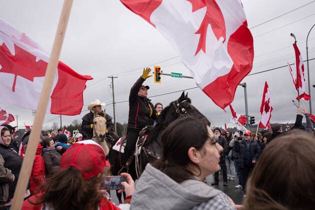 February 19, 2027, Surrey, British Columbia, Canada: A person on a horse hushes the crowd as to not spook her horse. The crowd cooperated and continued their rally against vaccine mandates at the US Canada border in Surrey, BC. Surrey Canada - ZUMA Pho 20270219_mda_w171_709 Copyright: xRyanxWalterxWagnerx