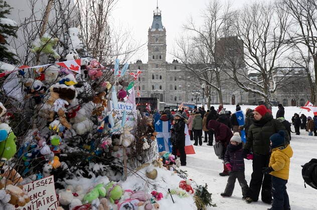 February 20, 2022, QUEBEC, PQ, Canada: A family checks the plush toys tree for kids to pick as hundreds of people demonstrate against COVID-19 measures Sunday, February 20, 2022 in front of the legislature in Quebec City. QUEBEC Canada  - ZUMAc35_ 20220220_zaf_c35_076 Copyright: xJacquesxBoissinotx