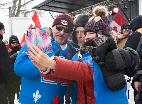February 20, 2022, QUEBEC, PQ, Canada: Convoy organizer Bernard Rambo Gauthier, left, gets his picture taken with supporters as hundreds of people demonstrate against COVID-19 measures Sunday, February 20, 2022 in front of the legislature in Quebec City. QUEBEC Canada  - ZUMAc35_ 20220220_zaf_c35_080 Copyright: xJacquesxBoissinotx