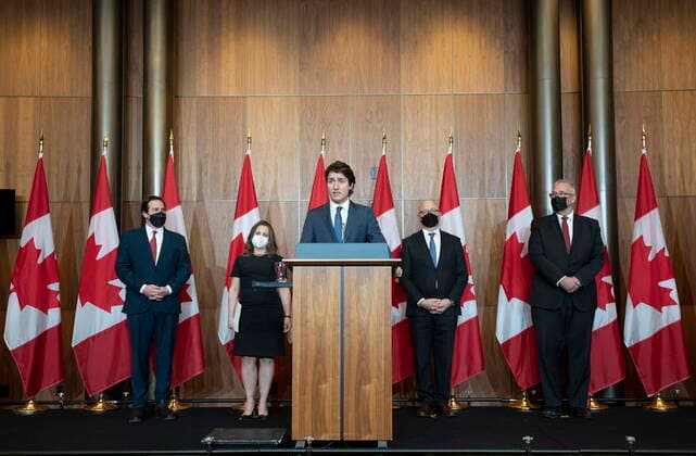 February 21, 2022, Ottawa, ON, Canada: Public Safety Minister Marco Mendicino, Deputy Prime Minister and Finance Minister Chrystia Freeland, Justice Minister and Attorney General of Canada David Lametti and President of the QueenöÄÃ s Privy Council for Canada and Emergency Preparedness Minister Bill Blair (left to right) look on as Prime Minister Justin Trudeau (centre) speaks during a news conference, Monday, February 21, 2022 in Ottawa. Ottawa Canada  - ZUMAc35_ 20220221_zaf_c35_018 Copyright: xAdrianxWyldx