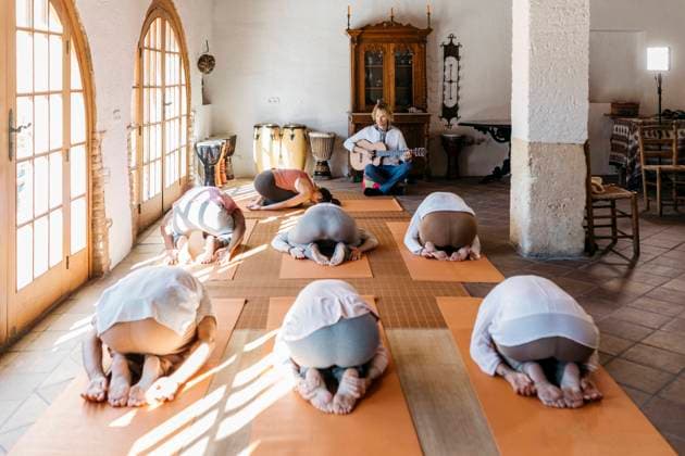 Musician playing in front of people exercising in yoga studio model released property released, JRFF05276