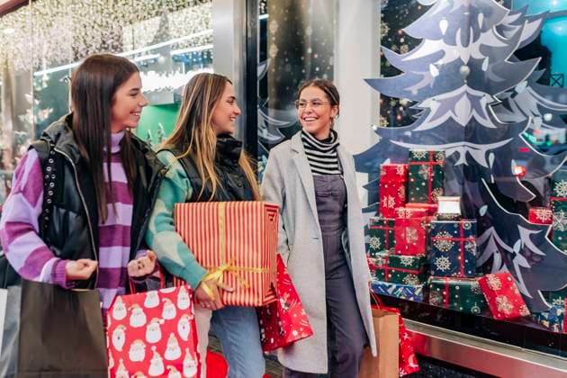 Smiling young friends walking with shopping bags by store model released, JRVF02707