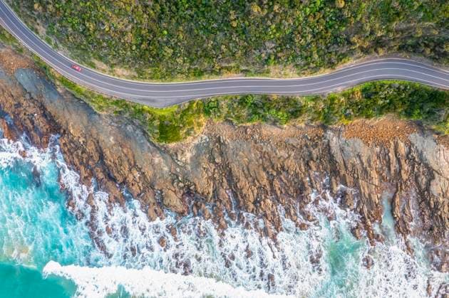 Australia, Victoria, Aerial view of rocky coastline and stretch of Great Ocean Road in summer, FOF12824