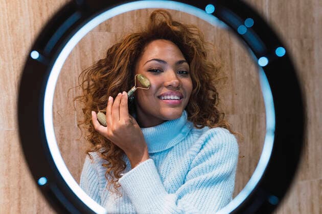 IMAGO Creative: Digitale Welt, Social Commerce Influencer with jade roller creating vlog in front of ring light model released property released, PNAF03147