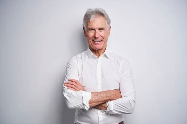 Confident businessman with arms crossed in front of white background model released, PNEF02656