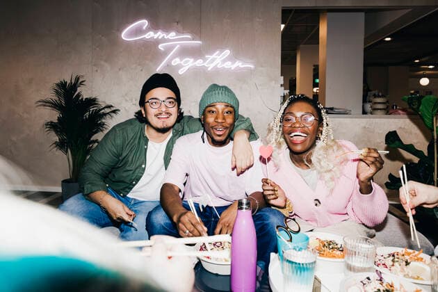 Portrait of cheerful multiracial male and female friends enjoying meal in college dorm Sweden, Stockholm, model released, property released Copyright: xMaskotx , MA92253