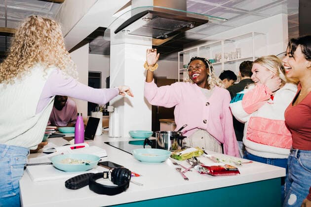 Happy multiracial young male and female friends having noodles in college dorm Sweden, Stockholm, model released, property released Copyright: xMaskotx , MA92278