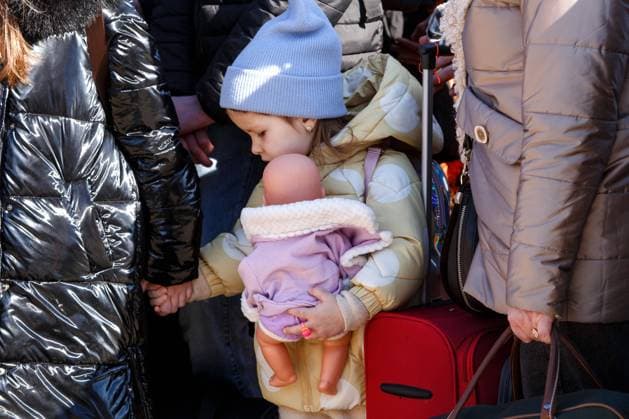 UZHHOROD, UKRAINE - FEBRUARY 27, 2022 - A little girl holding a woman s hand clutches a doll at the Uzhhorod-Vysne Nemecke checkpoint on the Ukraine-Slovakia border, Zakarpattia Region, western Ukraine. Refugees on Ukraine-Slovakia border  Copyright: xSerhiiHudakx
