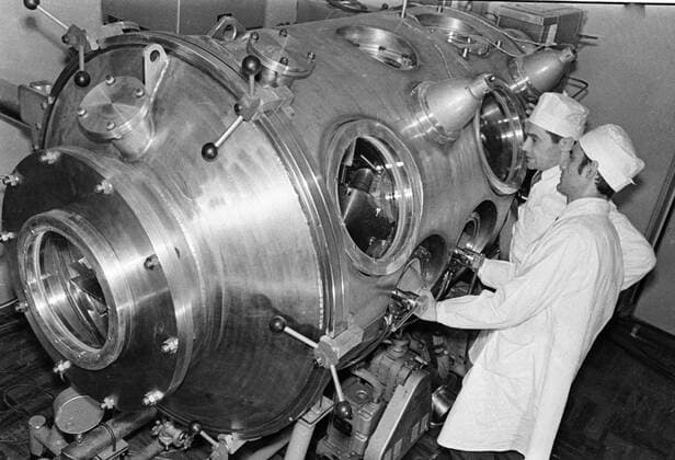 LUNAR ROCK CONTAINER 66241 05.02.1972 Assistants of the special laboratory of the USSR Academy of Sciences handling the moon rock container brought by the Soviet unmanned station Luna-20. RIA Novosti Sputnik Russia  Copyright: xRIAxNovostix