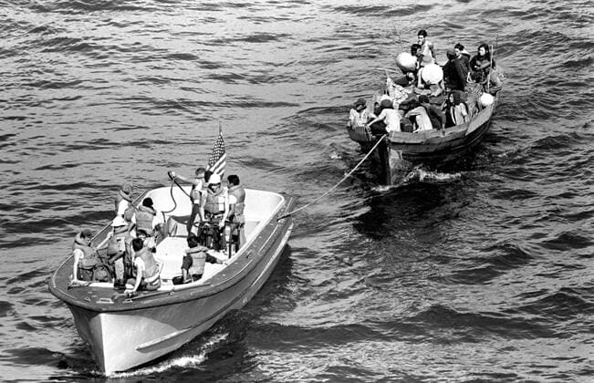 A life boat from the USS BLUE RIDGE (LCC 19) tows a Vietnamese fishing boat to the amphibious command ship. 35 Vietnamese refugeees were rescued 350 miles north of Cam Ranh Bay, Vietnam, after spending eight days at sea. 1062_05_l_-4572-