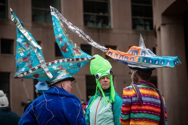 March 12, 2022, VANCOUVER, BC, CANADA: A person wearing a squid hat talks to other musicians wearing paper models of a sailboat and a Seabus vessel during a climate action rally organized by the group 350 Canada, in Vancouver, B.C., Saturday, March 12, 2022. VANCOUVER CANADA  - ZUMAc35_ 20220312_zaf_c35_020 Copyright: xDarrylxDyckx