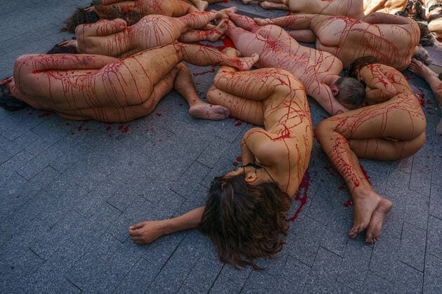 March 13, 2022, Madrid, Spain: (EDITOR s NOTE: Image contains profanity).Naked demonstrators covered in fake blood lie on Preciados street during a protest against the fur industry No Fur 2022 , in Madrid. The rally has been called as every year by the animal rights organization AnimaNaturalis to eradicate the use of animal fur in fashion and accessories. AnimalNaturalis was born to give a voice for animals that are used by humans for commercial purposes. Madrid Spain - ZUMAs197 20220313_zaa_s197_199 Copyright: xAtilanoxGarciax