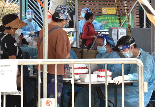 (220314) -- HONG KONG, March 14, 2022 -- Staff members register information for citizens at a mobile nucleic acid testing site in Hong Kong, south China, March 14, 2022. On Monday, Hong Kong registered 12,040 new COVID-19 cases by nucleic acid tests, and 14,868 additional positive cases through self-reported rapid antigen tests, official data showed. ) CHINA-HONG KONG-COVID-19-CASES (CN) LoxPingxFai