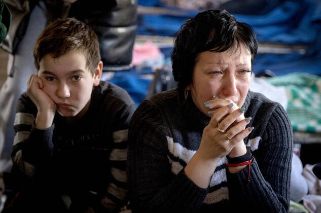 LUGANSK REGION, UKRAINE - MARCH 16, 2022: An evacuated woman and a child are seen at a reception point for residents of the city areas of Lisichansk, Rubezhnoye, and Severodonetsk, set up by the emergencies ministry of the Lugansk Peopleâ€™s Republic on the outskirts of Starobelsk for further evacuation. Tension began to escalate in Donbass on 17 February, with the Donetsk People s Republic and the Lugansk People s Republic reporting the most intense shellfire in months. Early on 24 February, Russia s President Putin announced his decision to launch a special military operation in response to requests from the leaders of the Donetsk People s Republic and the Lugansk People s Republic. Stanislav Krasilnikov TASS EDITORIAL USE ONLY; NO COMME  TS127F94