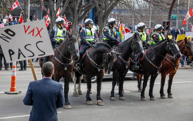 March 19, 2022, Calgary, AB, CANADA: Police officers on horse back keep watch as hundreds of demonstrators gather at city hall in Calgary, Alta., Saturday, March 19, 2022. Calgary CANADA  - ZUMAc35_ 20220319_zaf_c35_053 Copyright: xJeffxMcintoshx