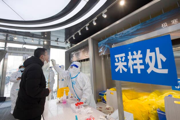 (220321) -- CHANGCHUN, March 21, 2022 -- A medical worker takes a swab sample from a resident for nucleic acid test at a COVID-19 testing site in Changchun, northeast China s Jilin Province, March 21, 2022. Changchun rolled out a new round of mass nucleic acid test on Sunday as a measure to combat the latest COVID-19 resurgence. (Photo by Xinhua) CHINA-JILIN-CHANGCHUN-COVID-19-TEST(CN) ZhangxYang 