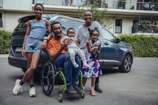 Cheerful disabled father with family at car model released, MFF08546