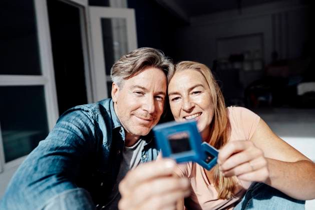Happy couple looking at photographic slide model released property released, KNSF09316