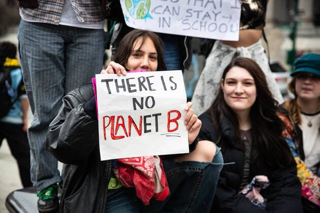 March 25, 2022, New York City, United States: A protester holds a sign reading, There is no planet B during the demonstration. Over a thousand youth climate activists marched from Brooklyn Borough Hall across the Brooklyn Bridge to Foley Square as part of a global climate strike. New York City United States - ZUMAs197 20220325_zaa_s197_298 Copyright: xKarlaxCotx