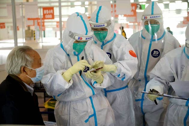 (220326) -- SHANGHAI, March 26, 2022 -- Staff members help a patient to register at a designated quarantine facility in east China s Shanghai, March 26, 2022. Local authorities have renovated seven venues, including hospitals and stadiums, to quarantine mild cases and asymptomatic carriers. (Photo by Xinhua) CHINA-SHANGHAI-COVID-19-QUARANTINE (CN) YexJiaqi 