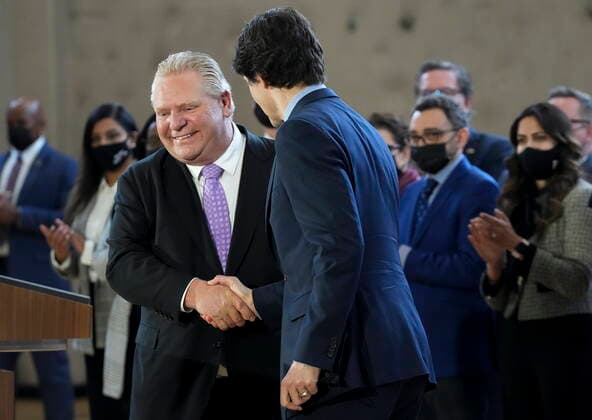 March 28, 2022, BRAMPTON, ON, CANADA: Prime Minister Justin Trudeau, right, shakes hands with Ontario Premier Doug Ford after reaching and agreement in $10-a-day child-care program deal in Brampton, Ont., on Monday, March 28, 2022. BRAMPTON CANADA - ZUMAc35_ 20220328_zaf_c35_019 Copyright: xNathanxDenettex