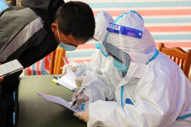(220328) -- SHANGHAI, March 28, 2022 -- A staff member registers information for a resident at a COVID-19 testing site in Fengxian District, east China s Shanghai, March 28, 2022. China s economic hub Shanghai launched a new round of nucleic acid testing across the city starting from 5 a.m. on Monday, local authorities said Sunday night. (Photo by Xinhua) CHINA-SHANGHAI-COVID-19-PREVENTION AND CONTROL (CN) WangxYanting 