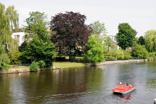 Two persons in a paddleboat, Alster, Hamburg, Germany., model released, , property released, , 33349968.jpg, adult, Alster, architecture, building, canal, channel, edifice, exterior, exterior shot, female, garden, Germany, green, Hamburg, home, house, human, idyllic, leisure-time activity, nature, outdoor, outdoor shot, outdoors, outside, paddleboat, pedal boat, pedalo, people, person, picturesque, recreation, relaxation, riparian property, river, riverside property, spare time job, summer, three, tree, two, water, watercourse, waterside property, waterway, woman