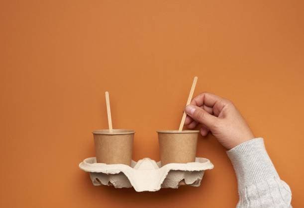 brown paper cups in a paper tray and a hand with a wooden stick on a brown background, no plastic, zero waste, model released, , property released, , 33701328.jpg, hand, hold, craft, cup, disposable, drink, eco, espresso, fast, food, go, holder, hot, large, latte, liquid, macchiato, mocha, mock up, mug, new, paper, portable, recycling, take, takeaway, takeout, tea, template, wooden, stick, recycle, background, beverage, blank, breakfast, brown, cafe, caffeine, cappuccino, cardboard, closeup, coffee, container, convenience