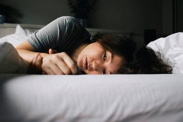 IMAGO Creative: 2022 Favoriten Creative Highlights Symbolbilder Tired woman suffering from mental health disorder lying on bed alone at home Germany, Berlin, model released, property released Copyright: xMaskotx , MA92657