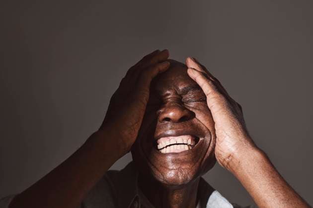 Creative Highlights Symbolbilder Elderly man laughing while covering face at studio Sweden, Stockholm, model released, property released Copyright: xMaskotx , MA92856