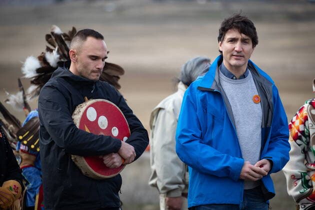 March 30, 2022, WILLIAMS LAKE, BC, CANADA: Prime Minister Justin Trudeau speaks as Williams Lake First Nation Chief Willie Sellars, left, listens during a visit to the former grounds of St. Joseph s Mission Residential School, in Williams Lake, B.C., on Wednesday, March 30, 2022. In January, the Williams Lake First Nation announced it had identified 93 reflections that could indicate the number of children buried around the site of the former residential school. WILLIAMS LAKE CANADA  - ZUMAc35_ 20220330_zaf_c35_114 Copyright: xDarrylxDyckx
